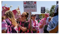 a group of people holding signs that say not war