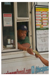 a man handing money to a girl at a food truck