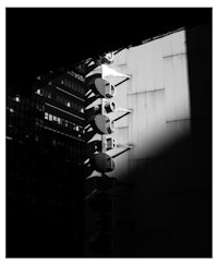 a black and white photo of a street light pole