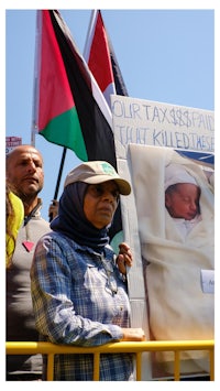 a woman holds a sign with a picture of a baby