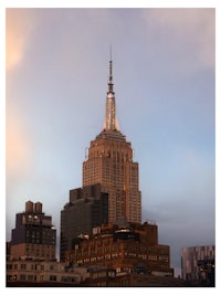 an image of the empire state building at sunset