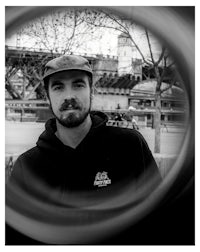 a black and white photo of a man in a hat