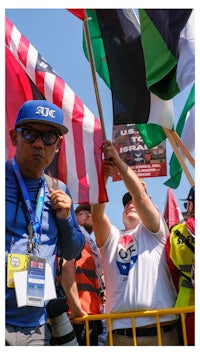 a group of people holding flags in front of a building