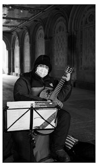 a man in a mask playing a guitar