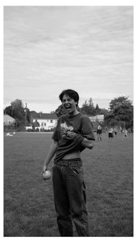 a man standing in a field holding a baseball